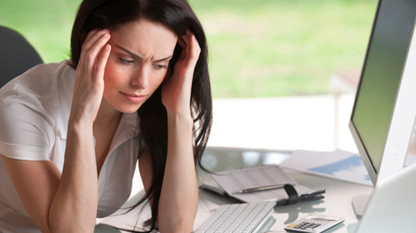 Attractive woman holding her head